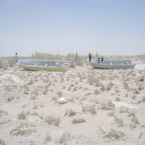 The Adimi, Dehno (new village), Sistan. Here is part of the Helmand water, which one entered the city and was used by the people, but which is now dried up. The fishermen’s boats are abandoned here and there in the dried land of the rivers and Hamun lagoon. From the series 'An Elegy for the Death of Hamun' (2018), image © Hashem Shakeri