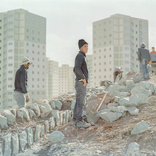 Still under construction: Workers in the new city of Parand. The city is located 30 kilometres southwest of the province of Tehran.