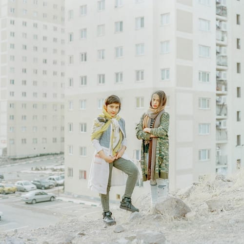 A portrait of Dorna and Sevda, both 12, walking around the town.